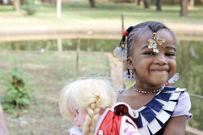 A little girl playing with a doll